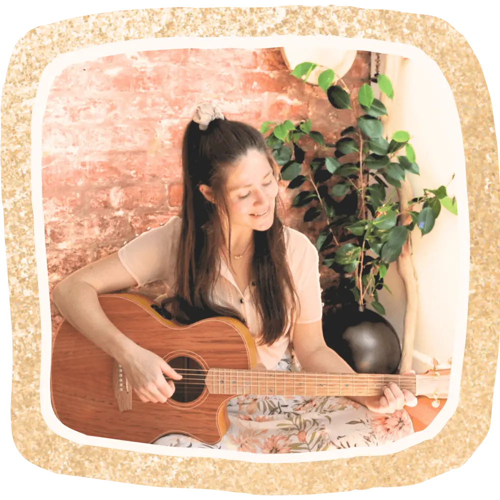Charmaine Silk playing and singing guitar for her song circle guests
